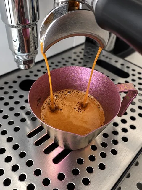 Espresso pouring from the machine into a cup at Zayn Coffee